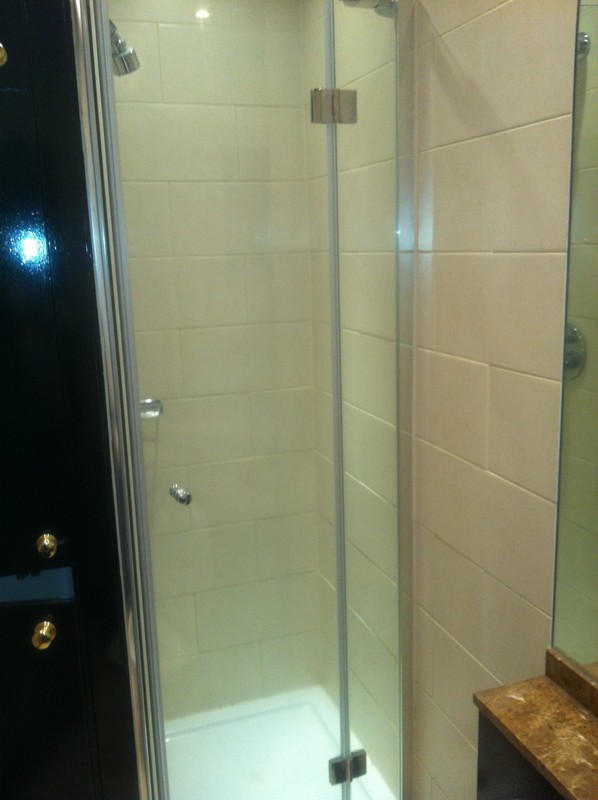 Frameless glass shower enclosure with chrome fittings in Camberwell