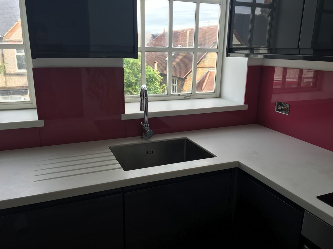 Deep plum coloured glass splashback in modern Camberwell kitchen